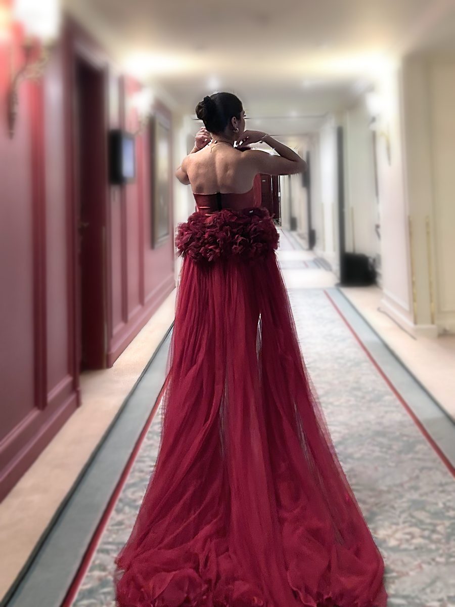 Juliette Carlon in a stage gown, Parisian palace hotel